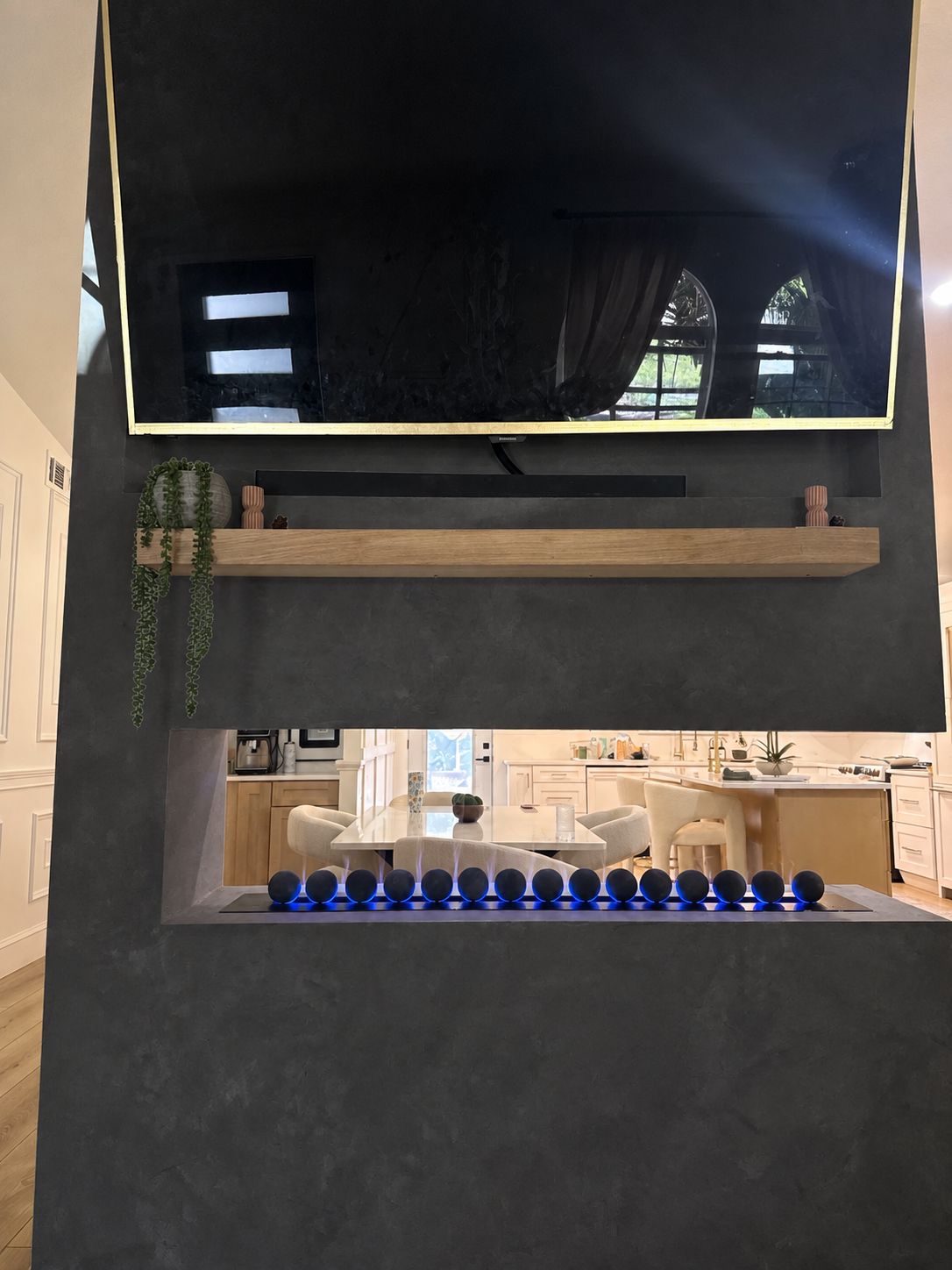 See-through vapor fireplace: Charcoal finish, an AI-edited design concept based on this project